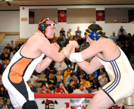 Marshfield 285-pounder Cale Schliesman, left, takes on Wausau West's Evan 