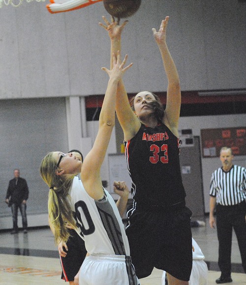 Marshfield's Hannah Meverden puts up a shot over Hudson's Kylee Christiansen during Tuesday's game at Marshfield High School. The Tigers won 45-42 in overtime. (Photo by Paul Lecker/MarshfieldAreaSports.com)