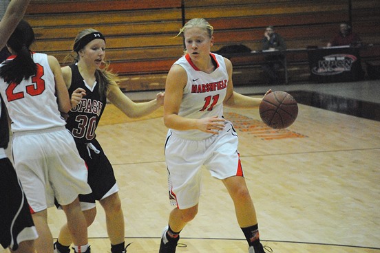 Marshfield's Jenna Jakobi drives around the Stevens Point defense during Friday's game at Marshfield High School. The Tigers won 63-58 to improve to 16-2 this season. (Photo by Paul Lecker/MarshfieldAreaSports.com)