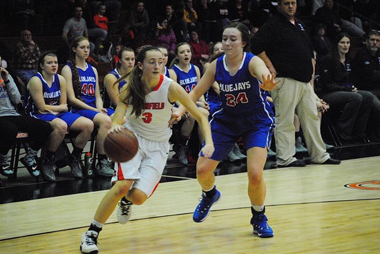 Marshfield's Meg Bryan drives the baseline past Merrill's Anna Finnell during the Tigers' 60-40 win on Friday night at Marshfield High School. (Photo by Paul Lecker/MarshfieldAreaSports.com)