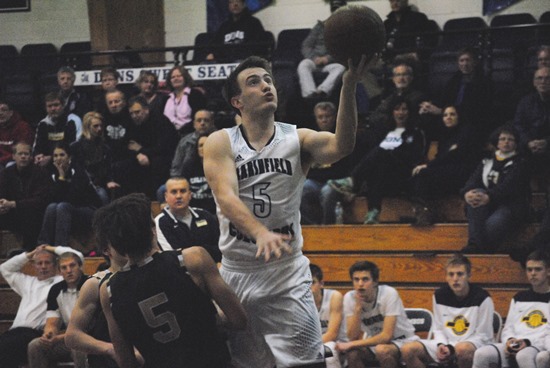 Columbus Catholic's Matthias Gouin drives in for a basket early in the second half of the Dons' 40-point win over Colby on Tuesday at Columbus Catholic High School. (Photo by Paul Lecker/MarshfieldAreaSports.com)