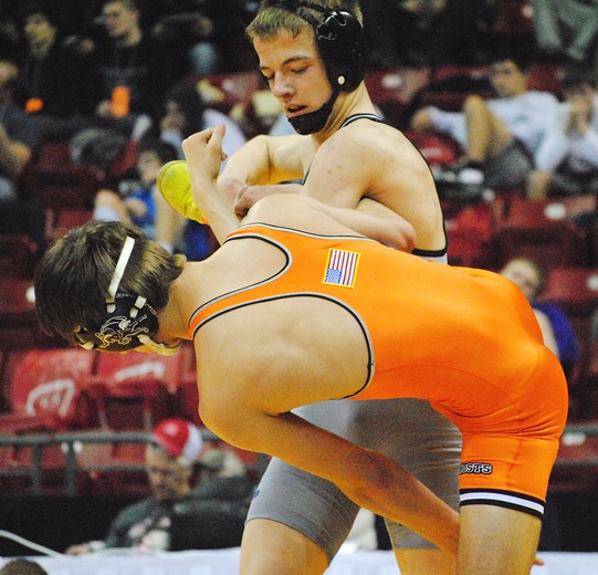 Marshfield freshman Nolan Hertel works to take down Kaukauna's Zach Lee during a Division 1 preliminary match at the 2016 WIAA State Individual Wrestling Tournament at the Kohl Center in Madison on Thursday. Hertel lost the match 9-1. (Photo by Paul Lecker/MarshfieldAreaSports.com)