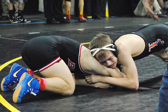 Marshfield's Nolan Hertel, right, tries to gain control of Sun Prairie's Drew Fjoser late in their Division 1 138-pound consolation match Friday morning at the WIAA State Individual Wrestling Tournament in Madison. Hertel lost 8-3. (Photo by Paul Lecker/MarshfieldAreaSports.com)