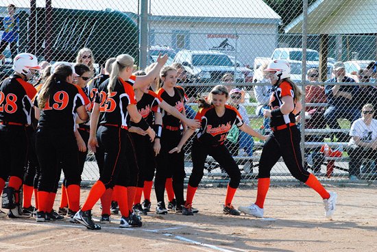 Marshfield's Megan Donahue, far right, is congratulated by her teammates after hitting a two-run homer in the first inning of the Tigers' game against D.C. Everest on Thursday at the Marshfield Fairgrounds. (Photo by Paul Lecker/MarshfieldAreaSports.com)