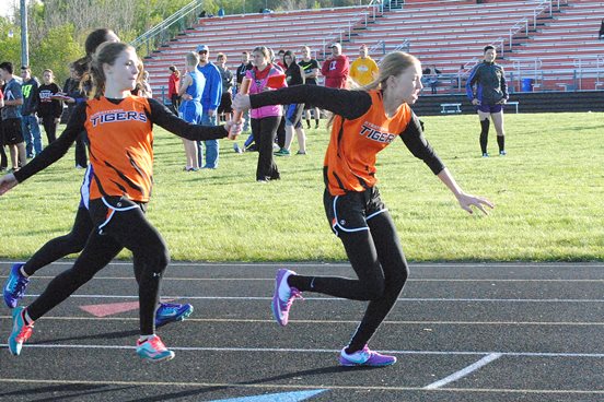Stratford's Sarah LaBorde, left, hands the baton to Callie Lehman for the third leg of the 800-meter relay at the Marawood Conference South Division Track & Field Meet on Monday at Tiger Stadium in Stratford. The Stratford team finished third in the event. (Photo by Paul Lecker/MarshfieldAreaSports.com)