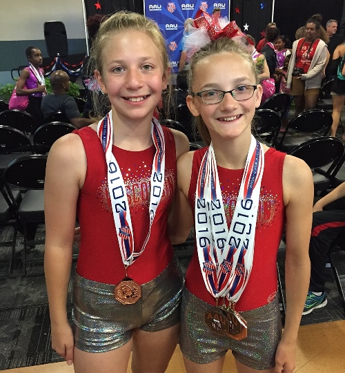 Marshfield MAGIC gymnasts Ashlyn Guldan, left, and Rachel Lindner show off their medals won at the AAU National Gymnastics Tournament at Disney World in Orlando, Fla., on July 1-2. (Photo submitted by Allie Dryer)