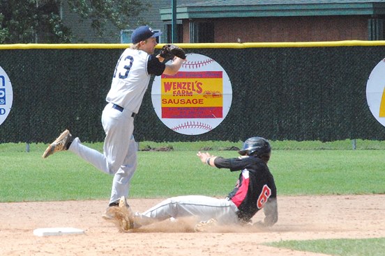Marshfield Post 54 shortstop Trevor Schwecke turns a double play to end the fifth inning Friday morning in the Blue Devils' game against Eau Claire in the Wisconsin Class AAA State American Legion Baseball Tournament at Jack Hackman Field in Marshfield. Eau Claire won 3-2. (Photo by Paul Lecker/MarshfieldAreaSports.com)
