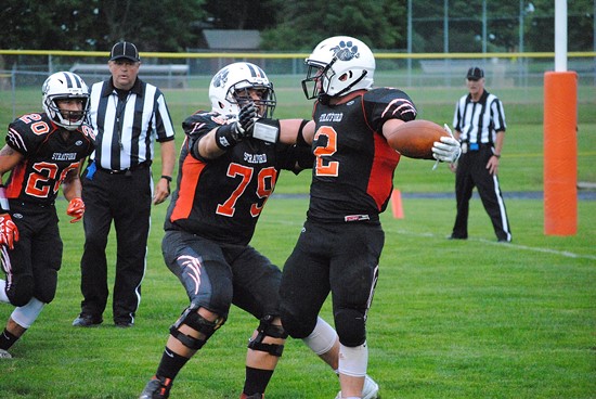 Stratford offensive lineman Tanner Weinfurtner (79) celebrates with Kam Bornbach after Bornbach scored a touchdown during the first quarter of the Tigers' 24-13 win over Marathon on Friday night at Tiger Stadium in Stratford. (Photo by Paul Lecker/MarshfieldAreaSports.com)