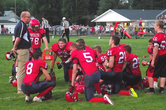 Spencer/Columbus head coach Jason Gorst, left, talks with his team during a timeout Friday night at Spencer High School. The Rockets beat Osseo-Fairchild to open their 2016 season. (Photo by Steve Pilz/For MarshfieldAreaSports.com)