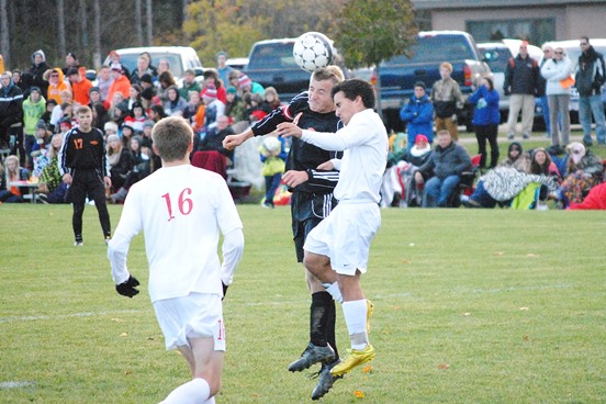 Marshfield senior Alec Hinson heads a shot during a game last season. Hinson is one of 10 returning seniors this year for the Tigers. (Photo by Paul Lecker/MarshfieldAreaSports.com)