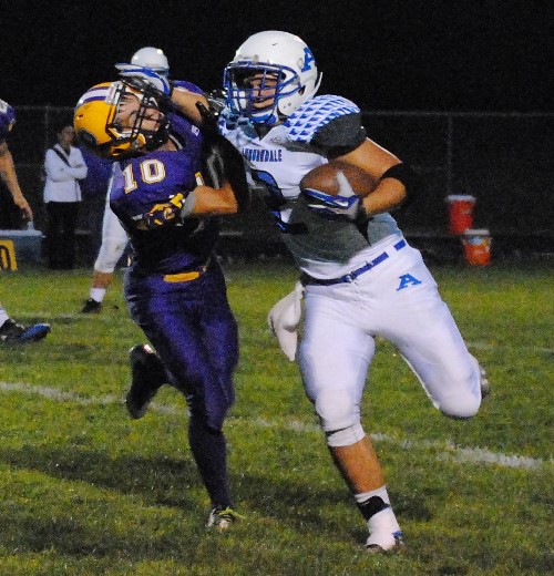 Auburndale running back Collin Hawkins stiff arms a Pittsville defender on his way to a first-down run during Friday night's game at Pittsville High School. The Apaches won 12-8. (Photo by Paul Lecker/MarshfieldAreaSports.com)