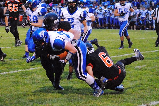 Marshfield's Paul Maguire and Austin Goode (6) wrap up an Oshkosh West ball carrier during the Tigers' 34-13 win on Friday at Beell Stadium. (Photo by Paul Lecker/MarshfieldAreaSports.com)
