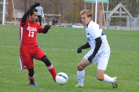 Columbus Catholic's Tyler Fuerlinger, right, dribbles past Arcadia's Jonathan Rodriguez early in a WIAA Division 4 boys soccer sectional semifinal Thursday at Griese Park in Marshfield. Fuerlinger scored three times, but the Dons lost 7-5. (Photo by Paul Lecker/MarshfieldAreaSports.com)