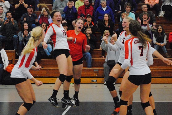 The Marshfield volleyball team celebrates after coming from behind to beat Eau Claire Memorial 3-2 in a WIAA Division 1 regional final Saturday night at Marshfield High School. (Photo by Paul Lecker/MarshfieldAreaSports.com)