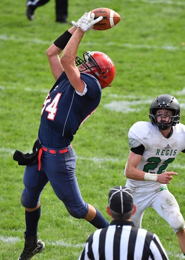 Spencer/Columbus' Hunter Luepke leaps for a pass in front of an Eau Claire Regis defender during Saturday's football game at Beell Stadium in Marshfield. Regis won 62-32. (Photo by Stuart Sundby/For MrshfieldAreaSports.com)