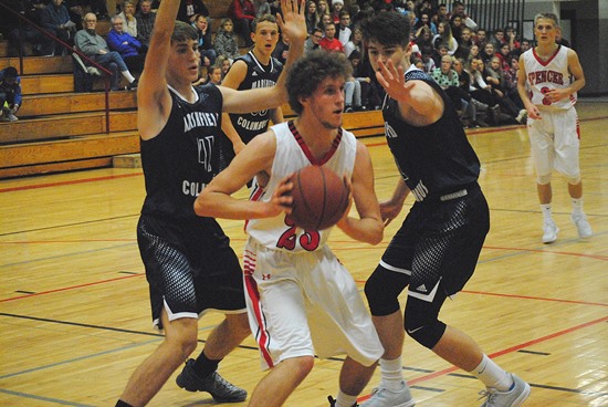 Spencer's Jacob Miller looks to pass the ball out of a double team by Columbus Catholic's Noah Hansen, left, and Jarred Mandel during Friday night's game at Spencer High School. (Photo by Paul Lecker/MarshfieldAreaSports.com)